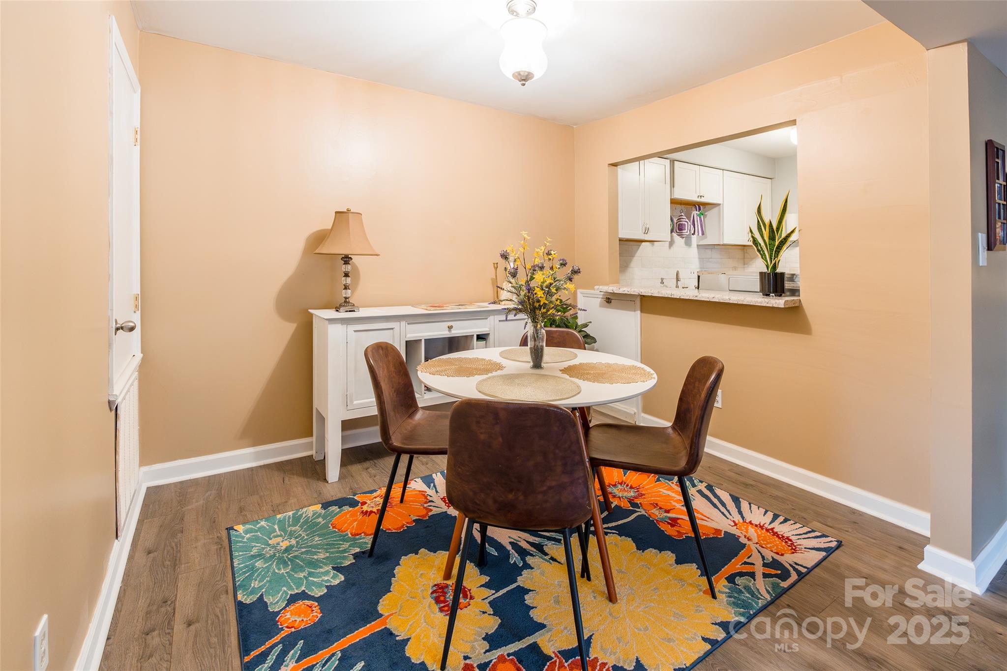 1604 Sharon Road West, Unit 23 Charlotte, NC 28210 - Photo 9 of 21 a view of a dining room with furniture and wooden floor
