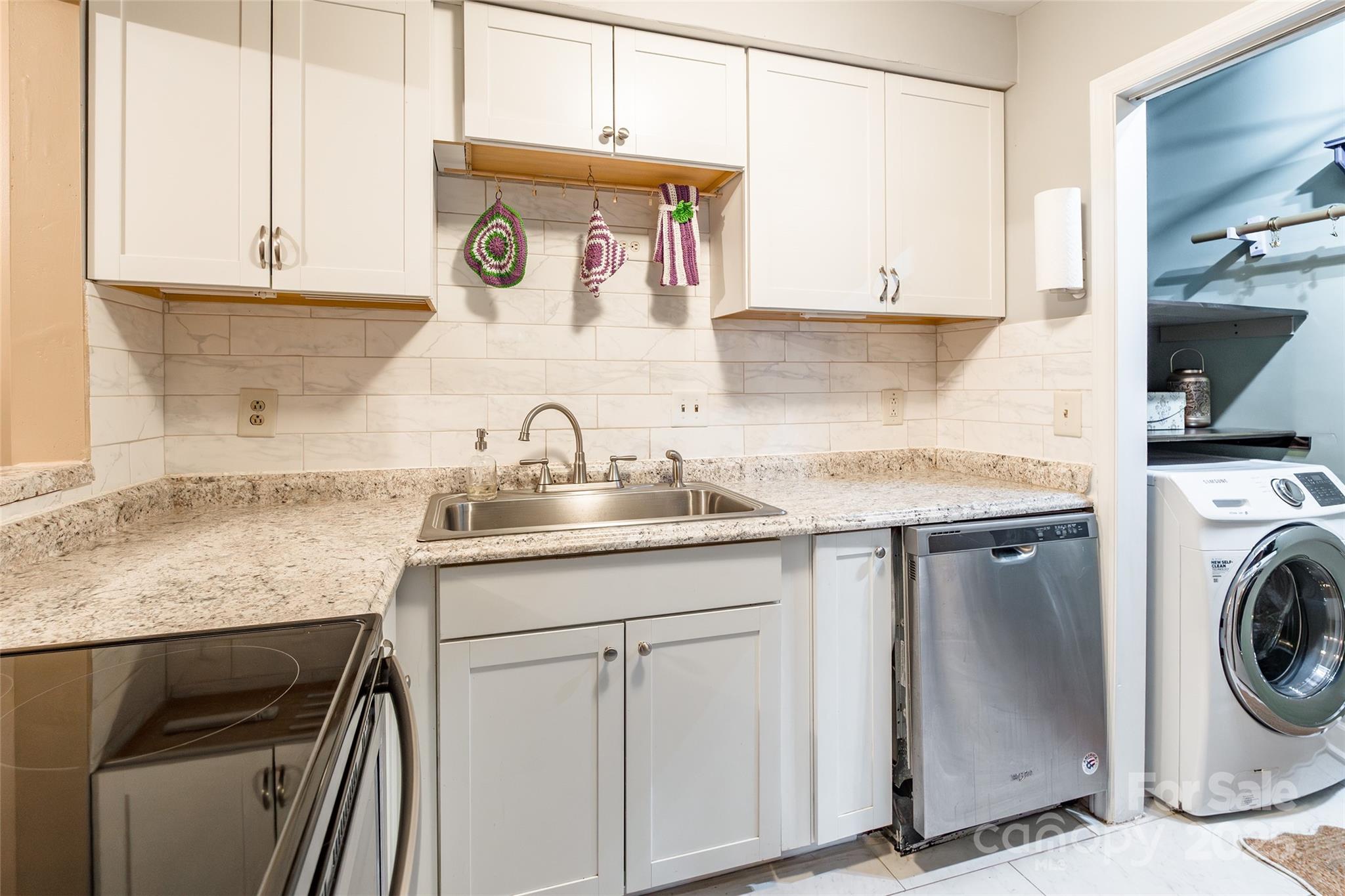 1604 Sharon Road West, Unit 23 Charlotte, NC 28210 - Photo 10 of 21 a utility room with cabinets washer and dryer