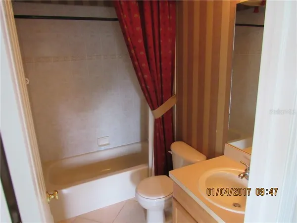 a bathroom with a toilet and a shower curtain