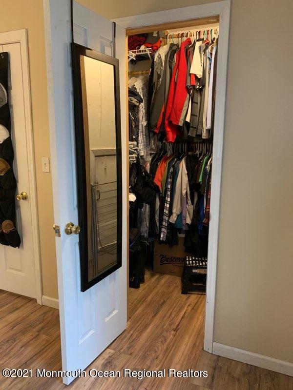 400 Cross Road, Unit A7 Matawan, NJ 07747 - Photo 6 of 10 a view of walk in closet with clothes and shoes