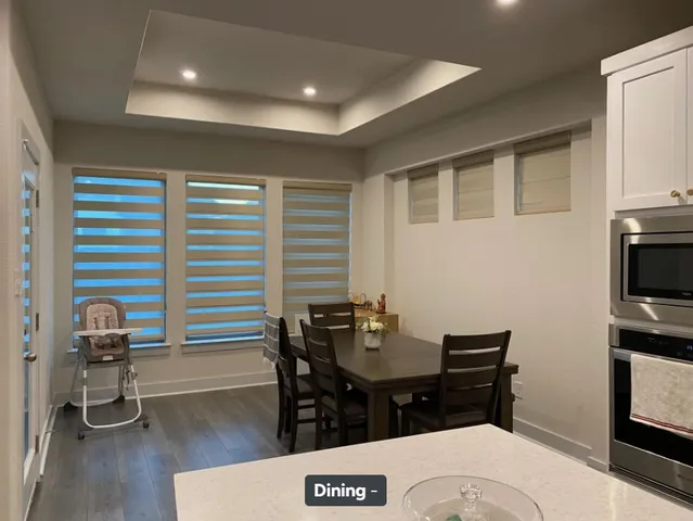 a kitchen with a refrigerator a stove a sink and white cabinets
