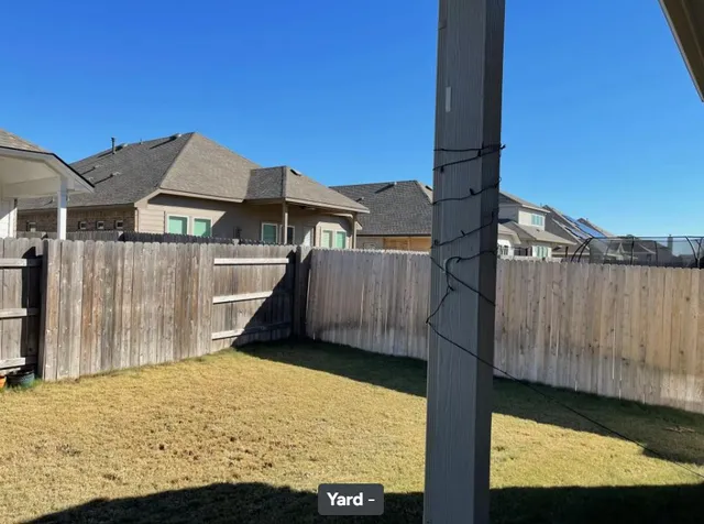 a bathroom with a toilet and a shower curtain