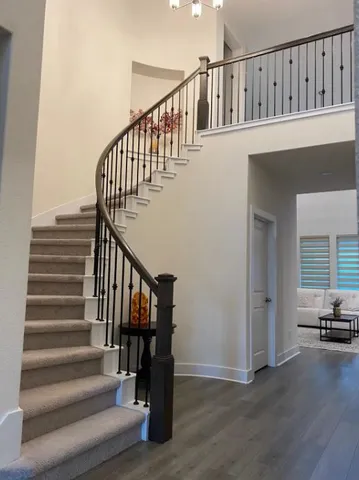 a view of entryway and hall with wooden floor