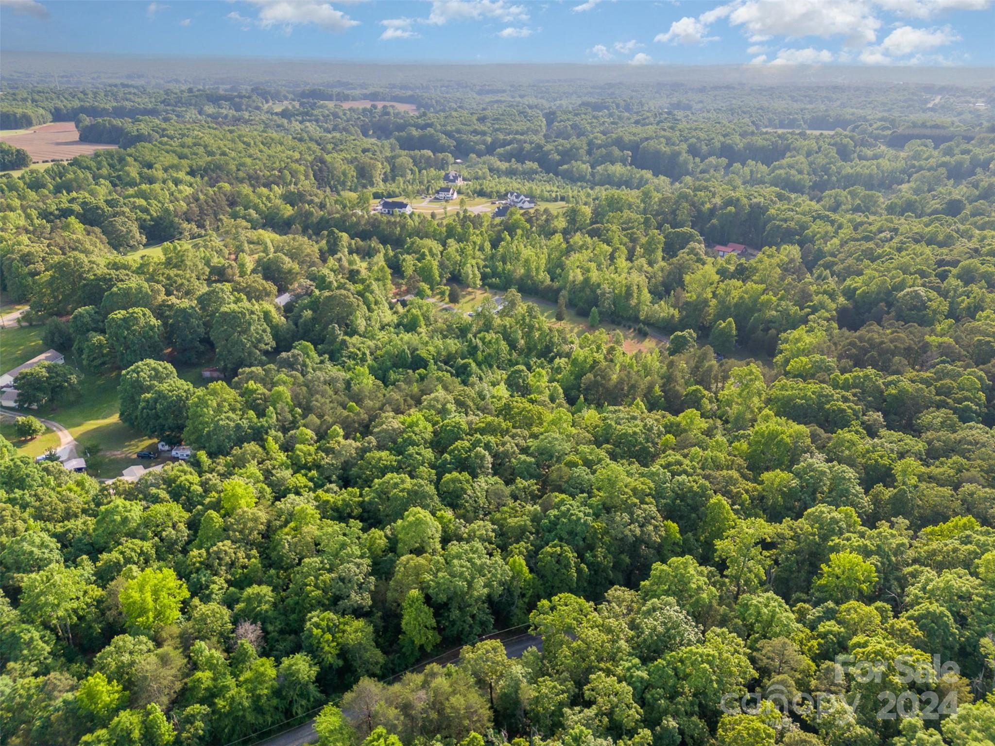 6720 Tuckaseegee Road Kannapolis, NC 28081 - Photo 13 of 16 a view of a city with lush green forest