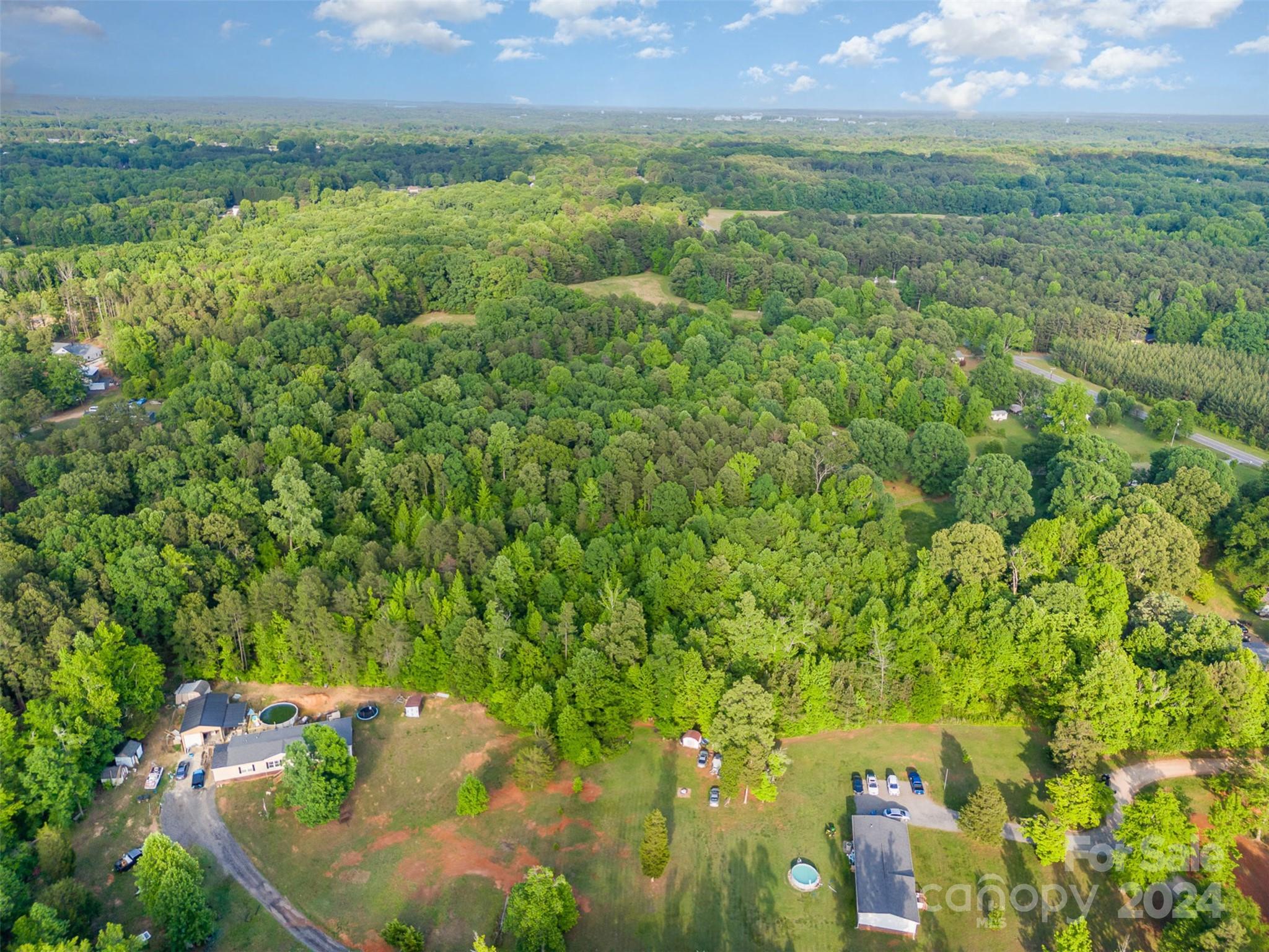 6720 Tuckaseegee Road Kannapolis, NC 28081 - Photo 15 of 16 a view of a lake with a field