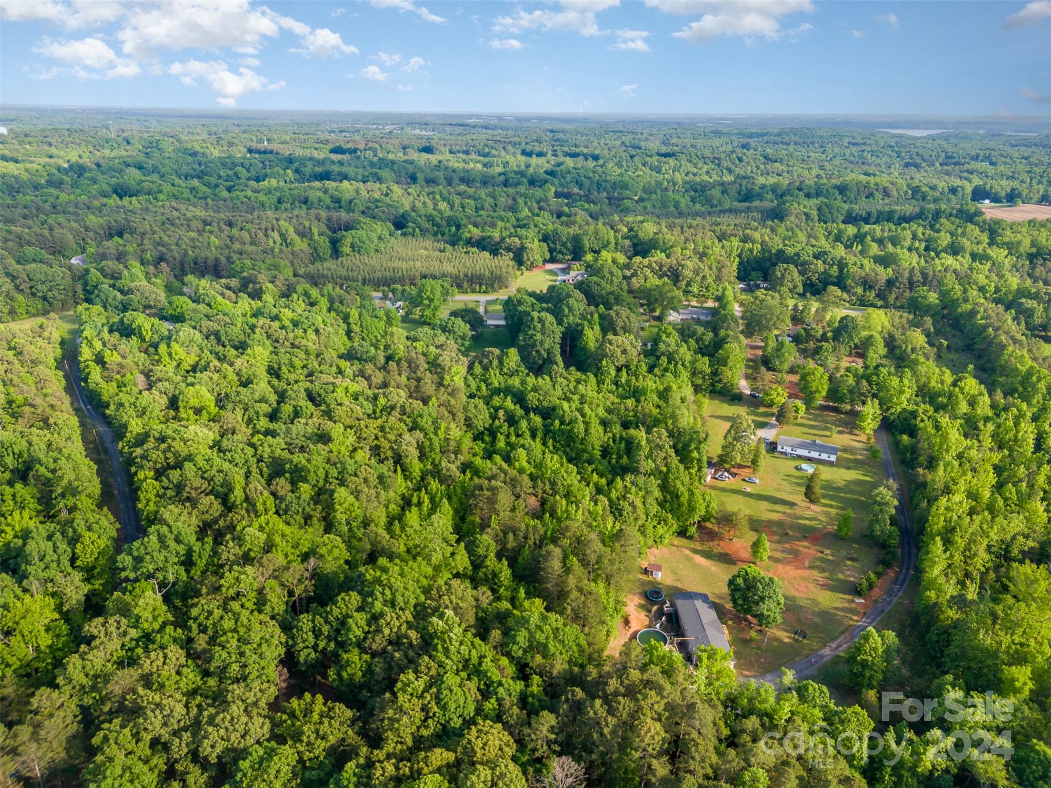 6720 Tuckaseegee Road Kannapolis, NC 28081 - Photo 2 of 16 a view of a city with lush green forest