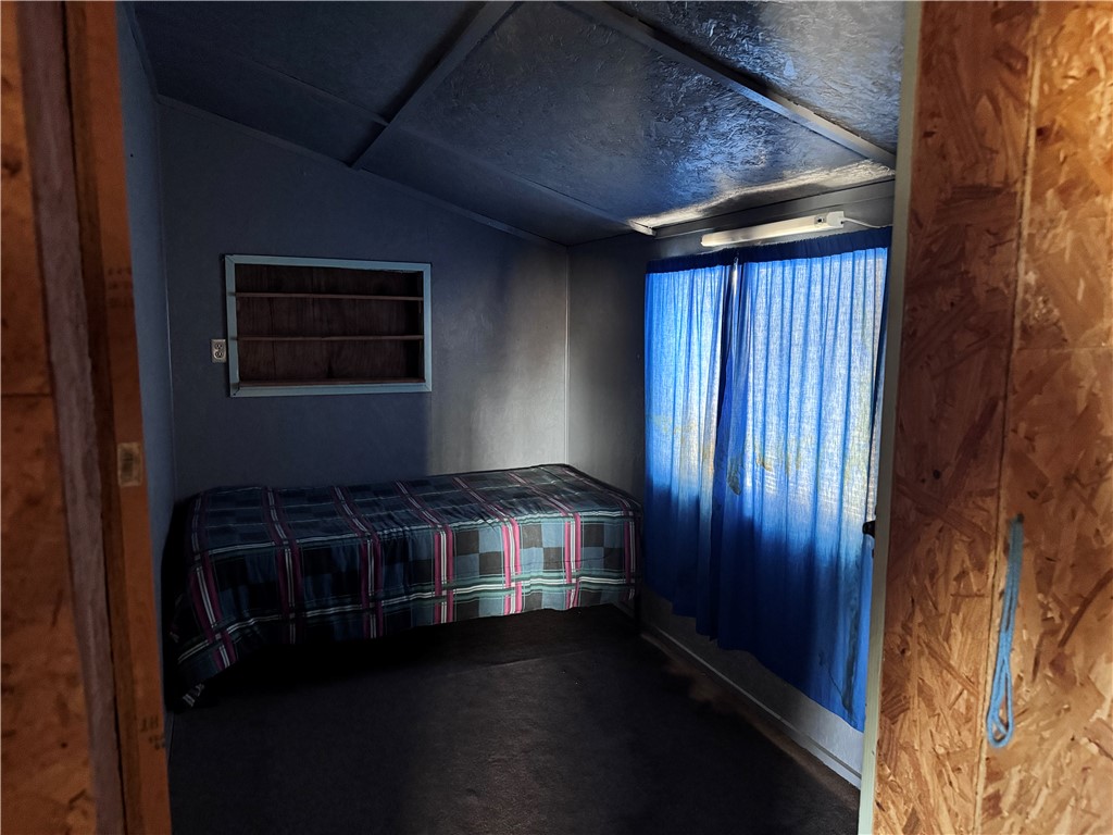 21188 South Cheyenne Road Yucca, AZ 86438 - Photo 10 of 24 Unfurnished bedroom with lofted ceiling