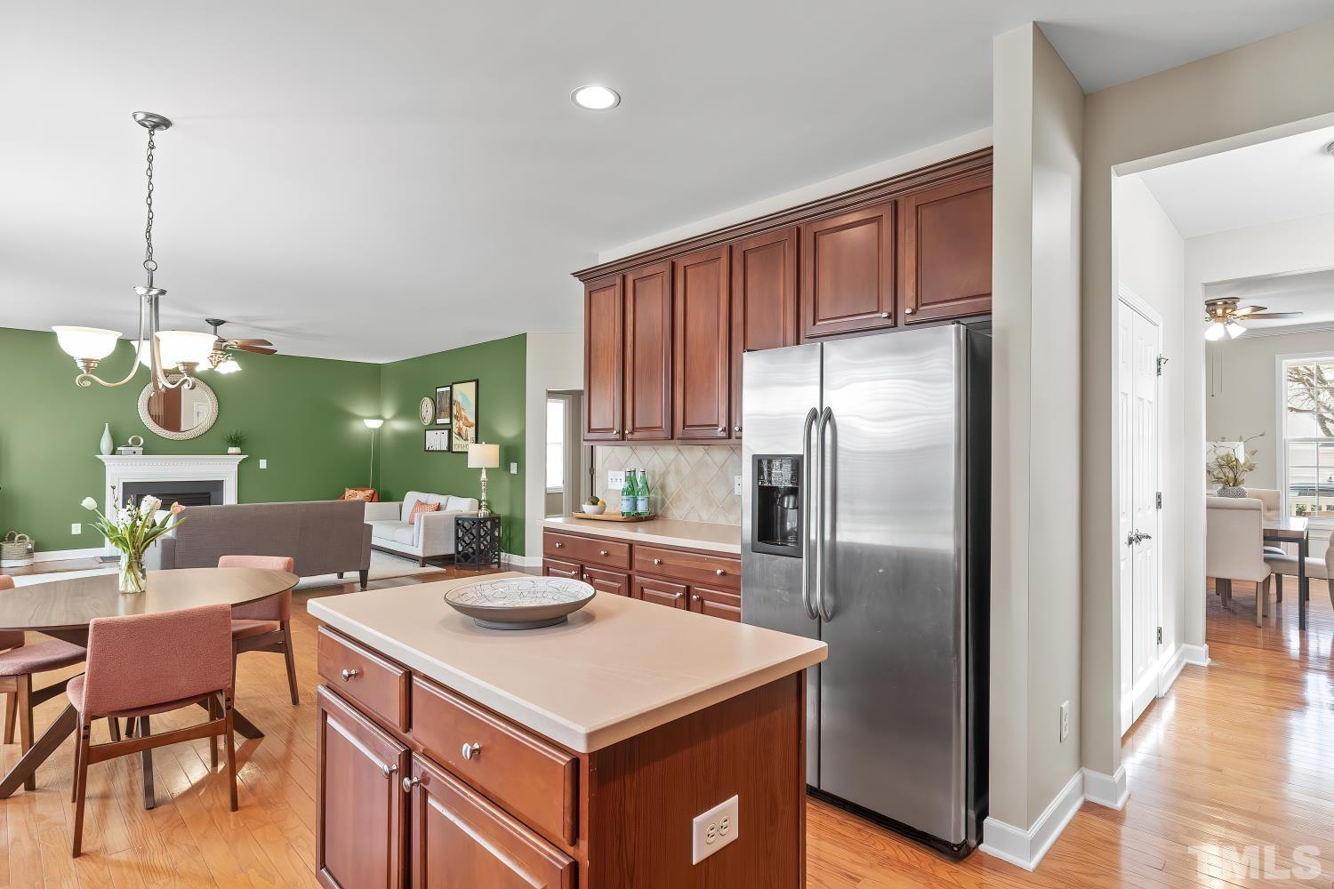 5225 Holly Ridge Farm Road Raleigh, NC 27616 - Photo 16 of 61 a kitchen with a refrigerator a table and chairs in it