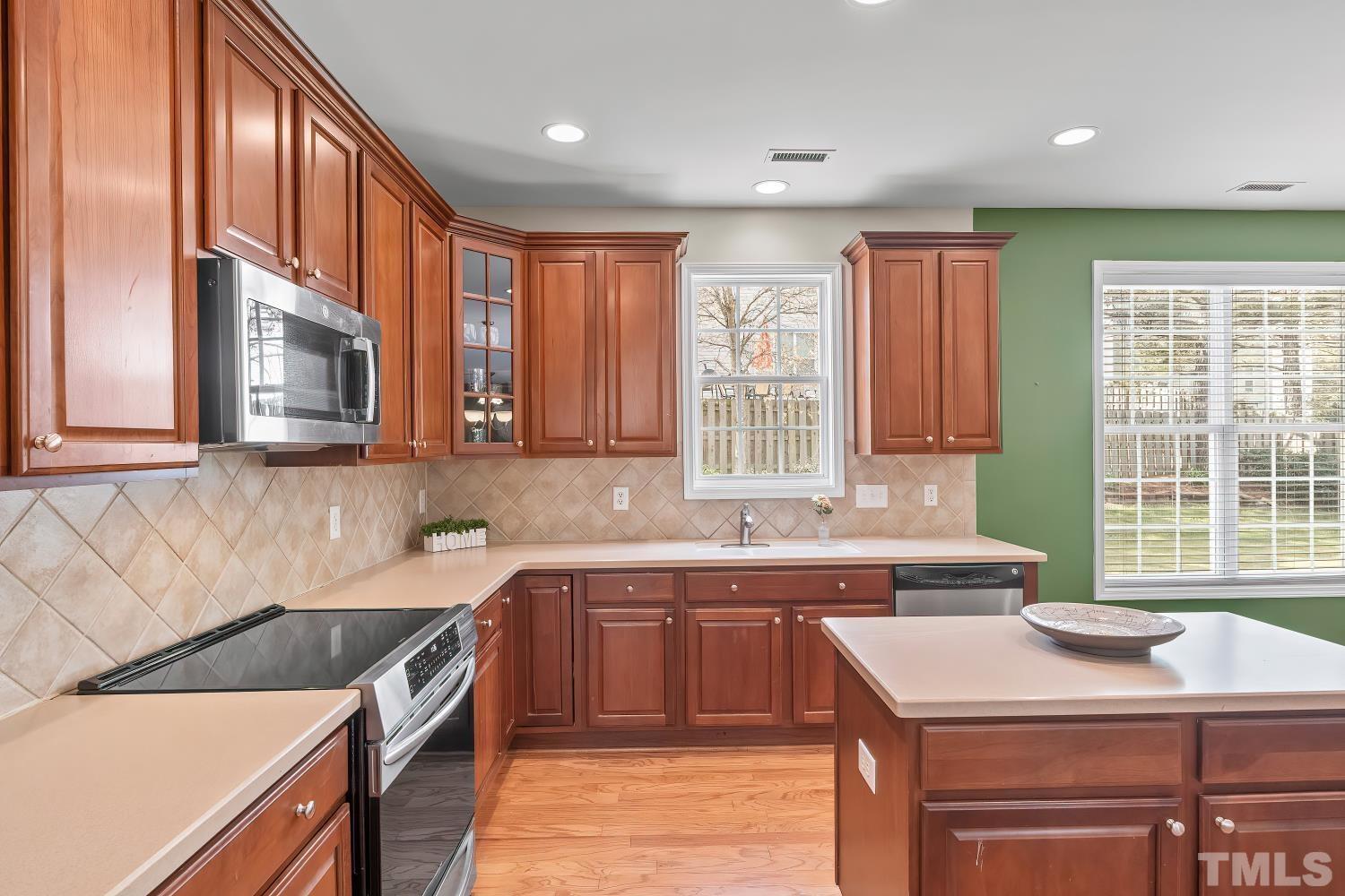 5225 Holly Ridge Farm Road Raleigh, NC 27616 - Photo 17 of 61 a kitchen with a sink stove and cabinets