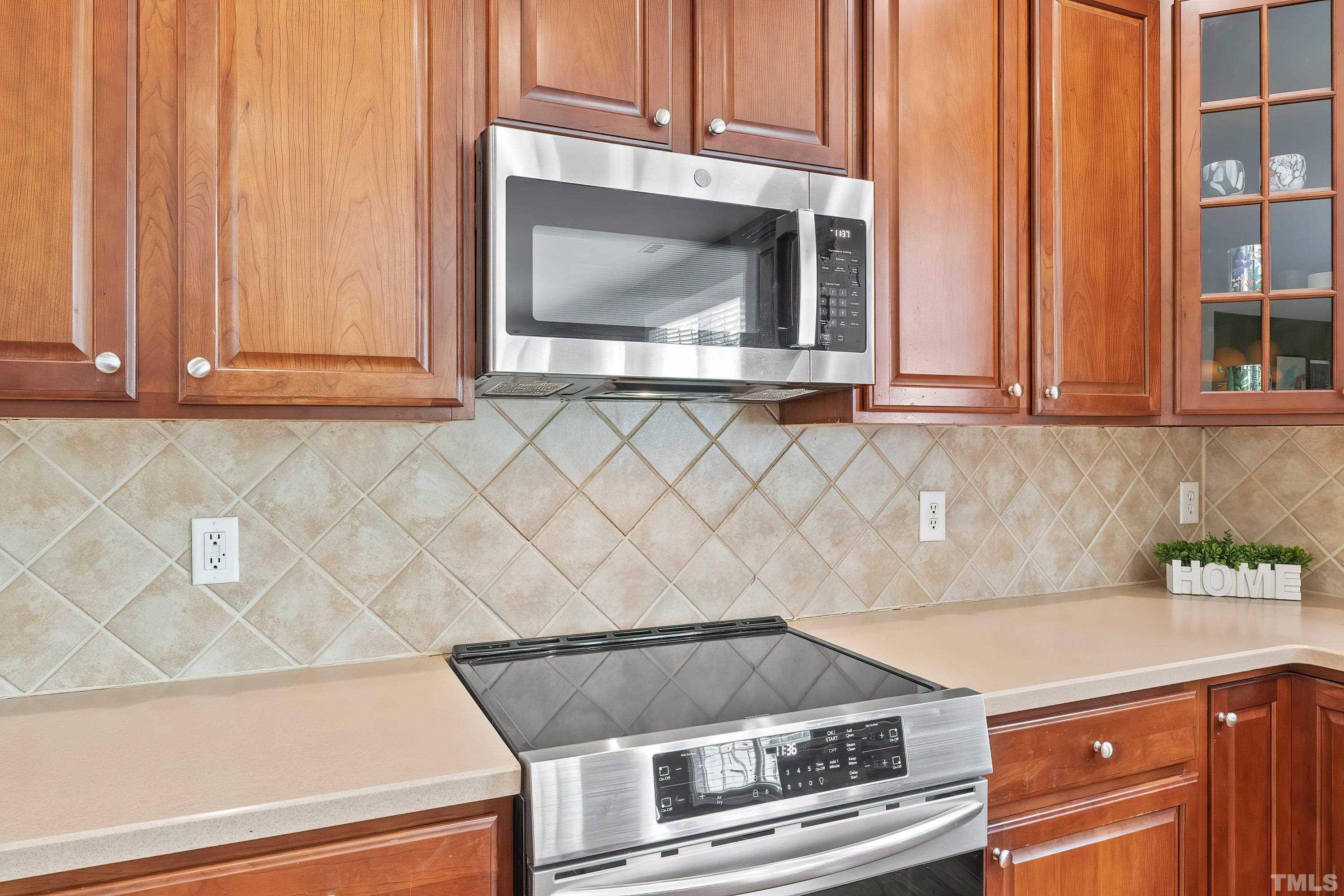 5225 Holly Ridge Farm Road Raleigh, NC 27616 - Photo 20 of 61 a kitchen with granite countertop white cabinets and a stove top oven