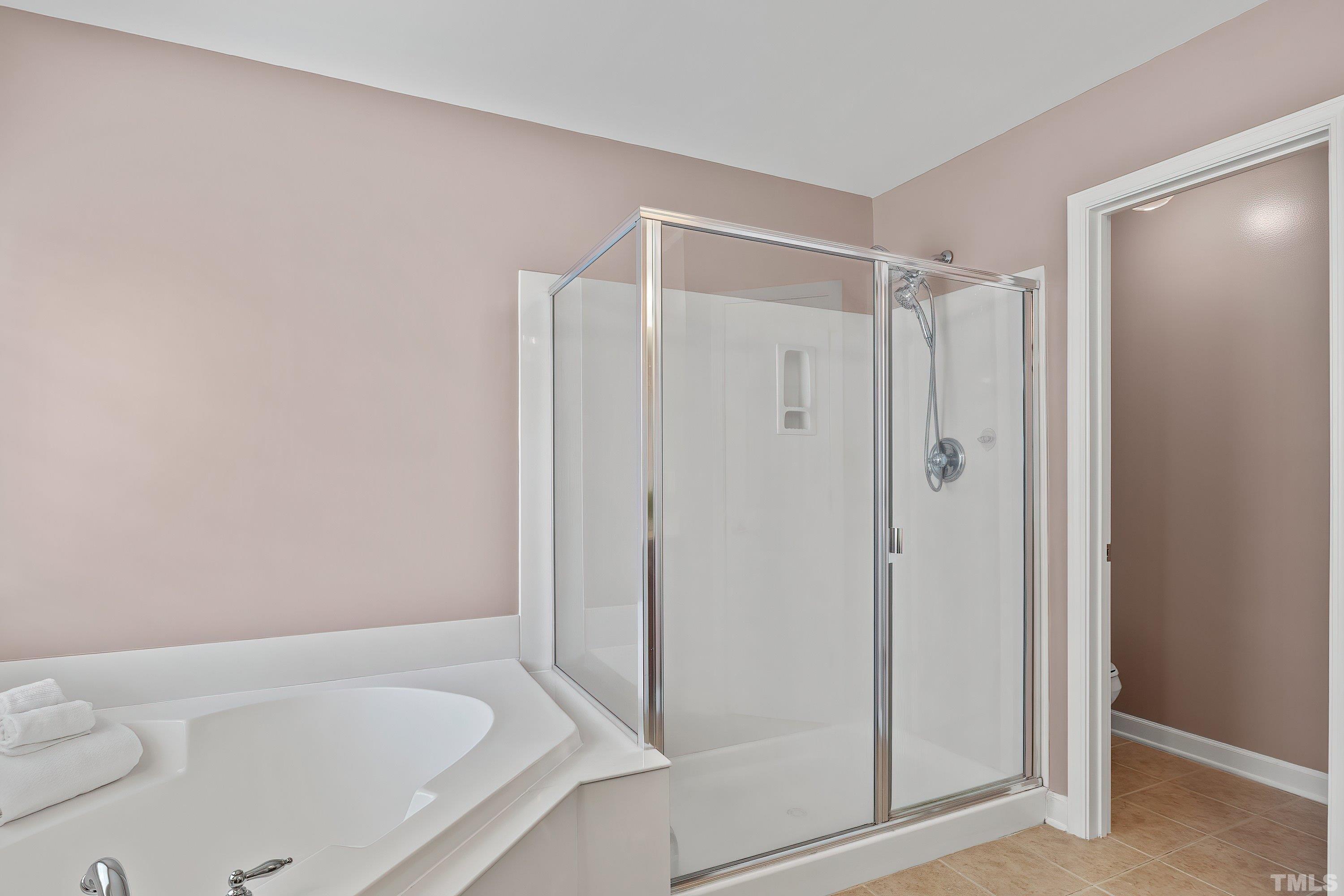 5225 Holly Ridge Farm Road Raleigh, NC 27616 - Photo 31 of 61 a bathroom with a shower and a tub