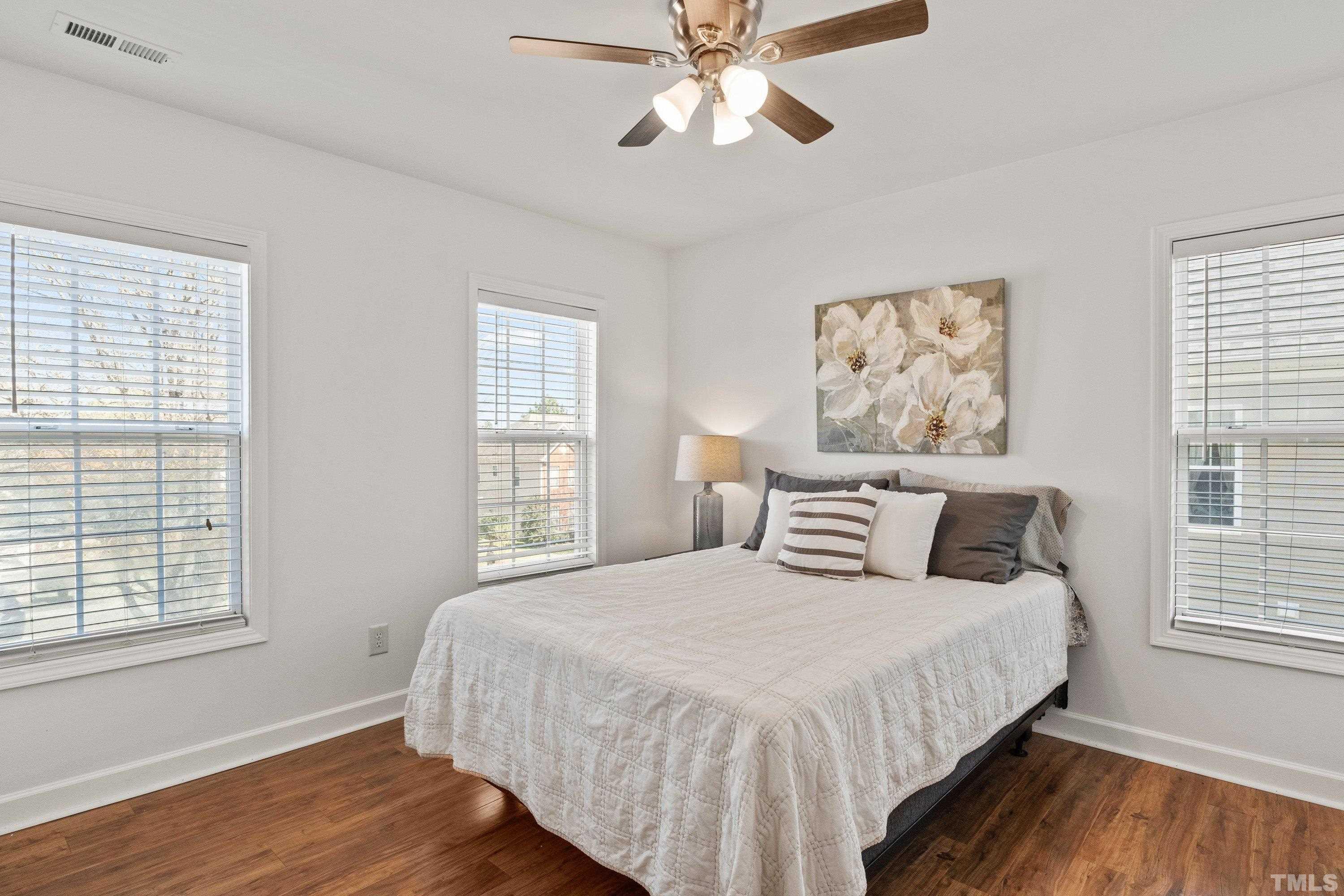 5225 Holly Ridge Farm Road Raleigh, NC 27616 - Photo 34 of 61 a bedroom with a large bed and a window
