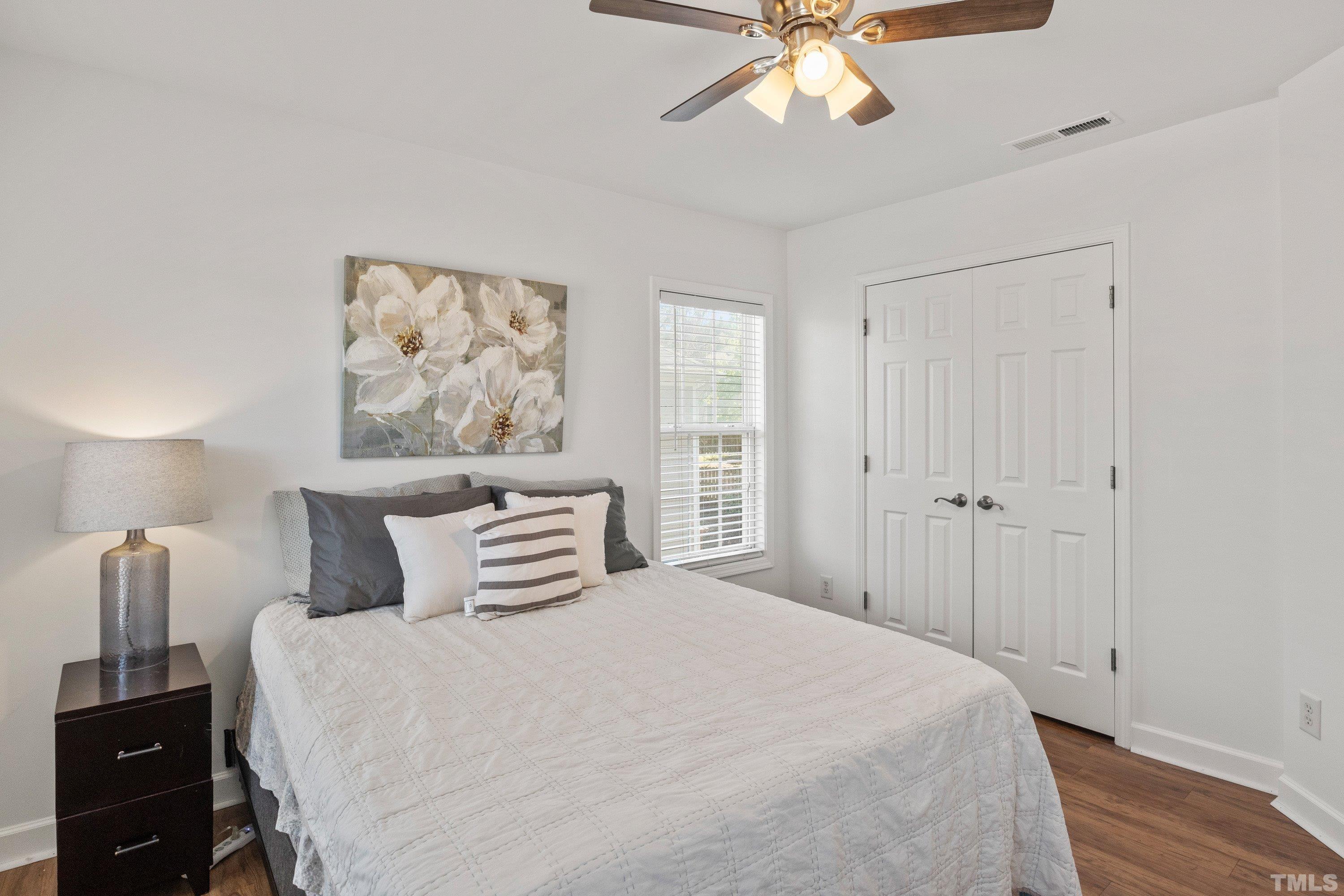 5225 Holly Ridge Farm Road Raleigh, NC 27616 - Photo 35 of 61 a bedroom with a bed and wooden floor