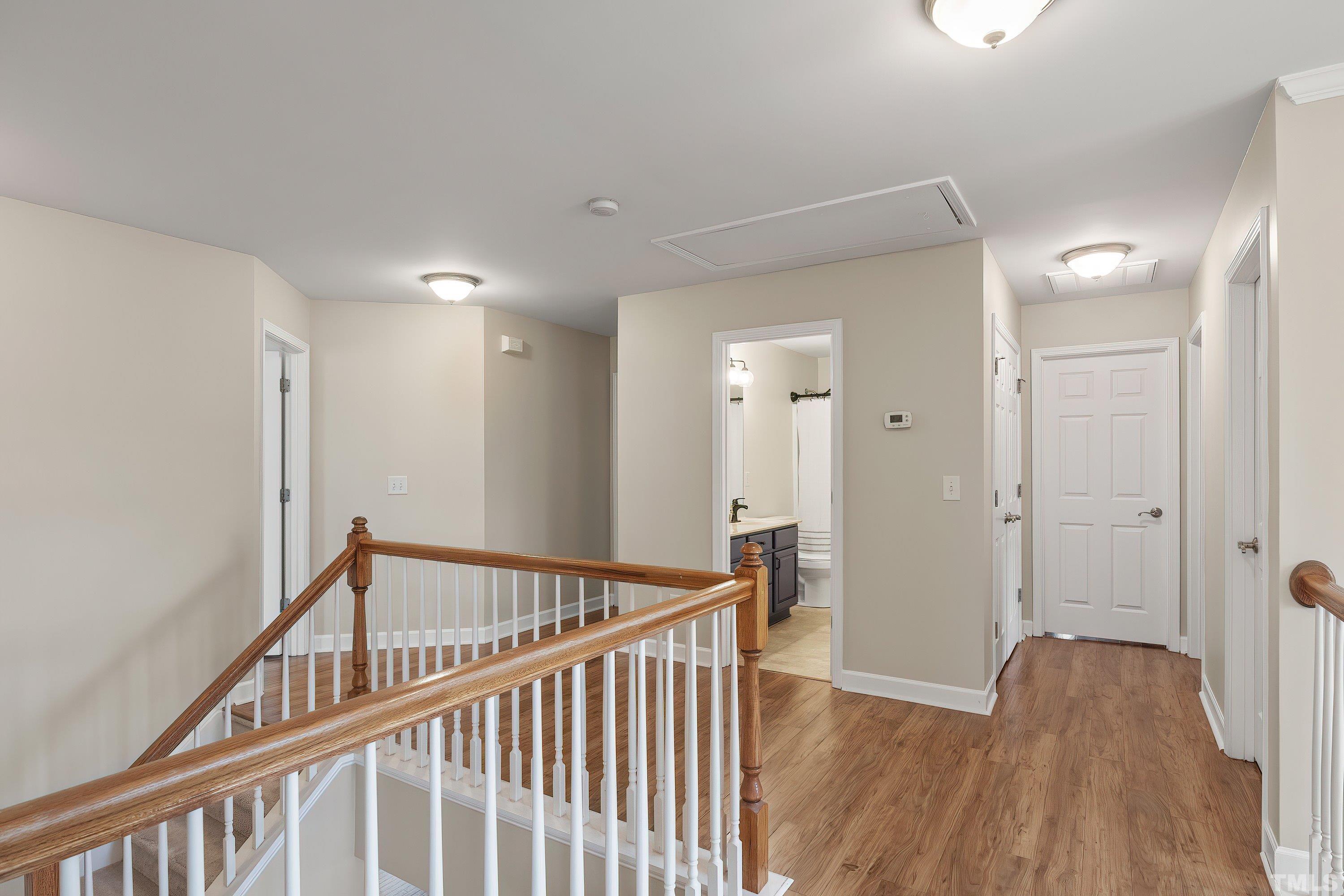 5225 Holly Ridge Farm Road Raleigh, NC 27616 - Photo 36 of 61 a view of a hallway with wooden floor and a bathroom