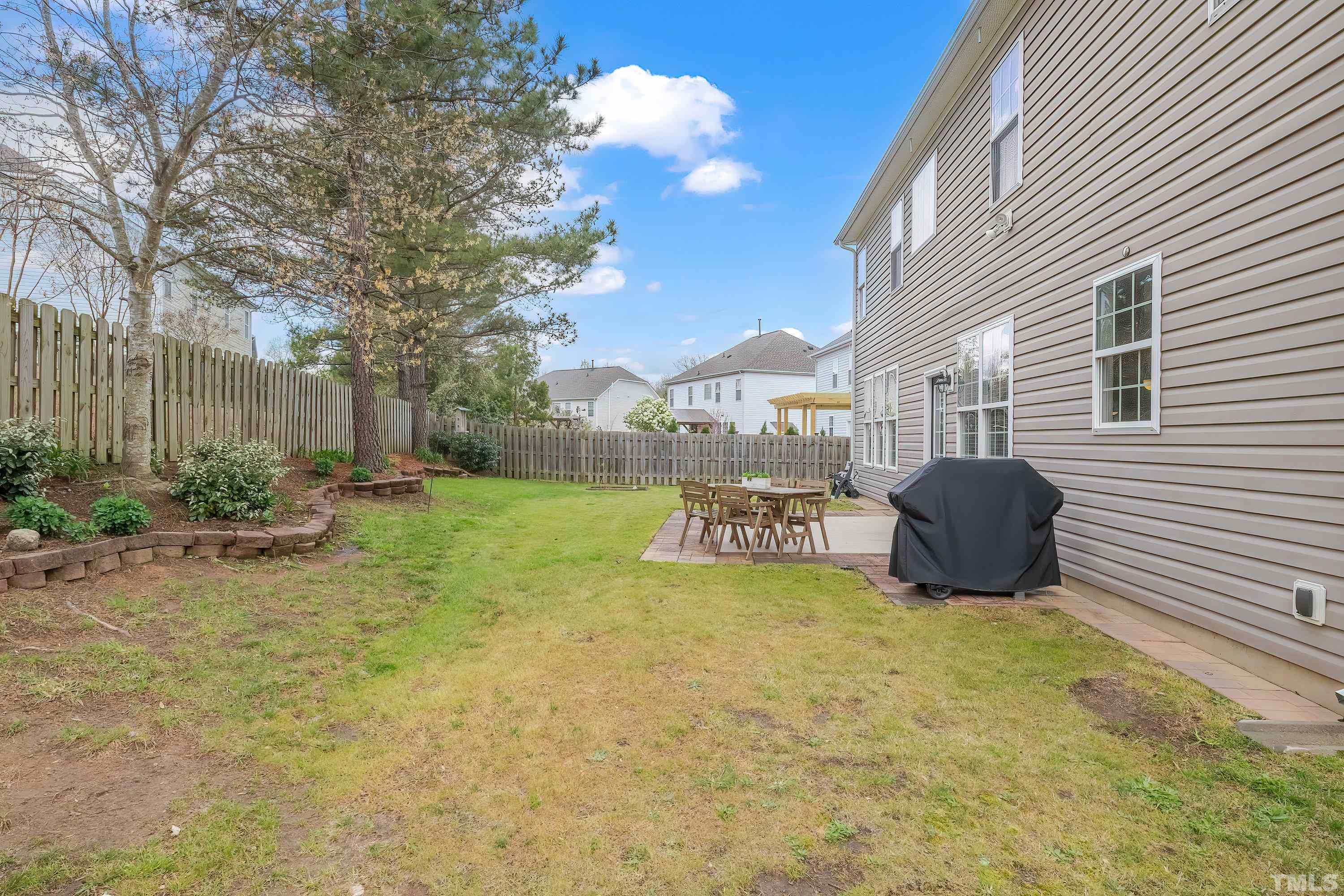 5225 Holly Ridge Farm Road Raleigh, NC 27616 - Photo 47 of 61 a view of a backyard with table and chairs and a fire pit