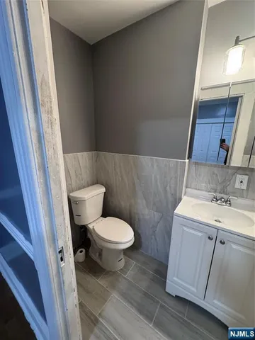 a white toilet sitting next to a bathroom sink