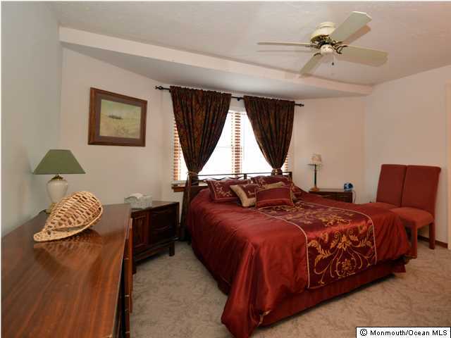 201 Forman Avenue Point Pleasant Beach, NJ 08742 - Photo 11 of 25 a bed room with a bed and a chandelier