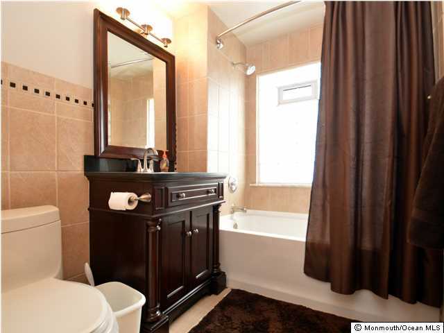201 Forman Avenue Point Pleasant Beach, NJ 08742 - Photo 21 of 25 a bathroom with a toilet a sink and a mirror