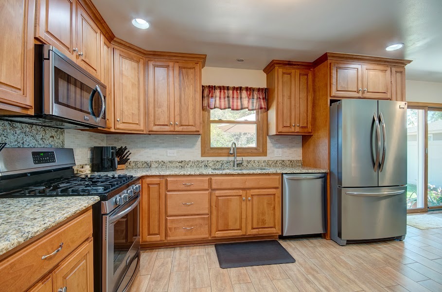 23019 South Kent Road Channahon, IL 60410 - Photo 11 of 36 a kitchen with stainless steel appliances granite countertop a stove a sink dishwasher a refrigerator and cabinets with wooden floor