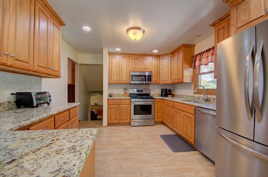 23019 South Kent Road Channahon, IL 60410 - Photo 12 of 36 a kitchen with stainless steel appliances granite countertop a refrigerator stove top oven and sink