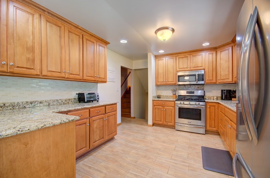 23019 South Kent Road Channahon, IL 60410 - Photo 14 of 36 a kitchen with granite countertop a refrigerator stove top oven and sink