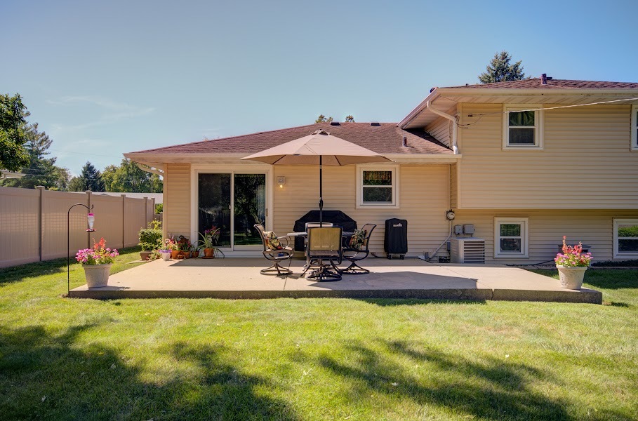 23019 South Kent Road Channahon, IL 60410 - Photo 3 of 36 a patio with a table and chairs under an umbrella