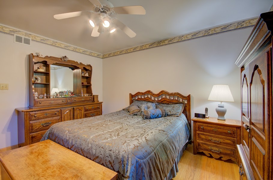 23019 South Kent Road Channahon, IL 60410 - Photo 8 of 36 a bedroom with a bed and dresser with mirror