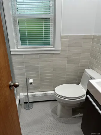 a white toilet sitting next to a window