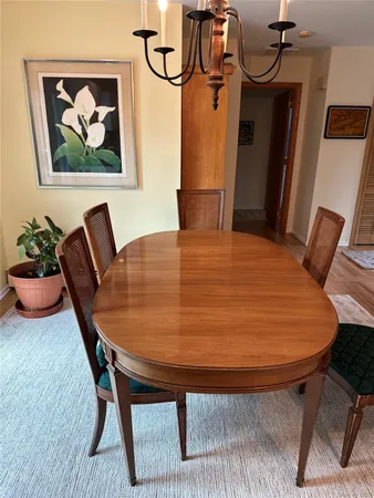 a dining room with furniture and wooden floor