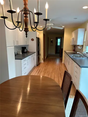 a kitchen with granite countertop a sink a stove and cabinets