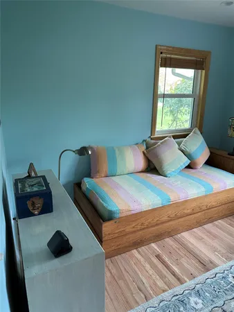 a bedroom with two beds and a window