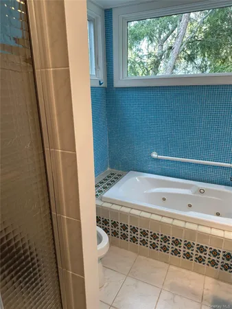 a bathroom with a bathtub and window