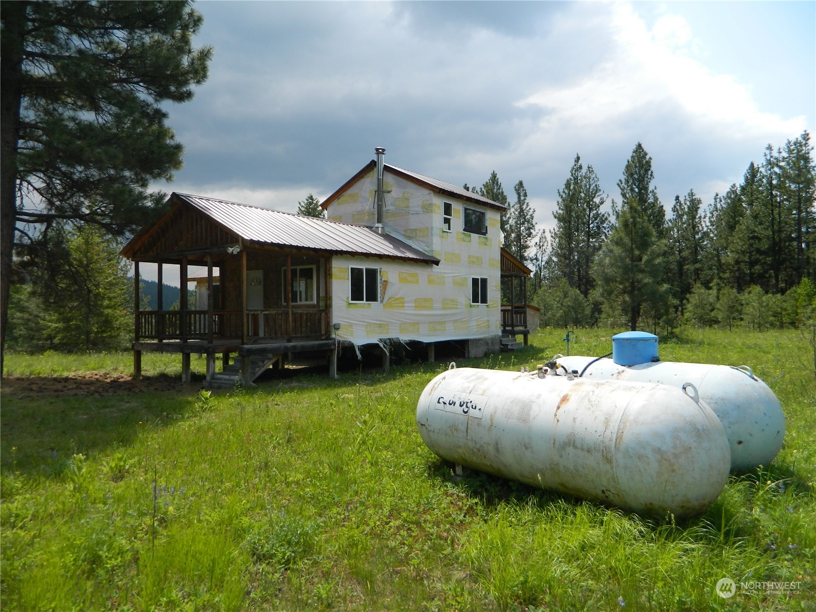 a view of an house with backyard space and balcony