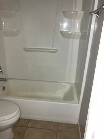 a bathroom with a bathtub and toilet