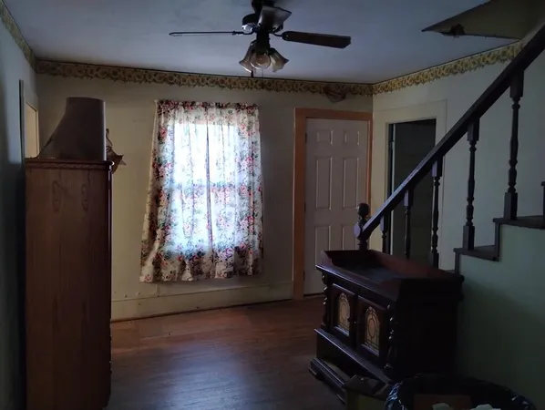 a living room with furniture and a dresser