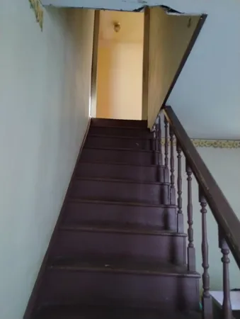 a view of a hallway with wooden floor and a chandelier
