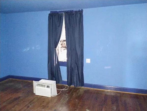 an empty room with wooden floor