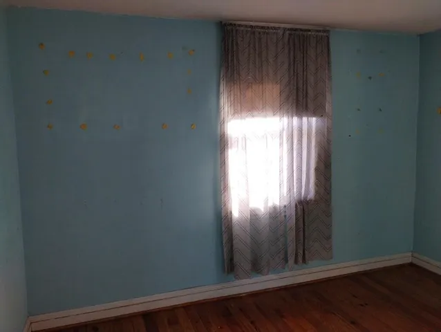 a view of a livingroom with furniture and staircase
