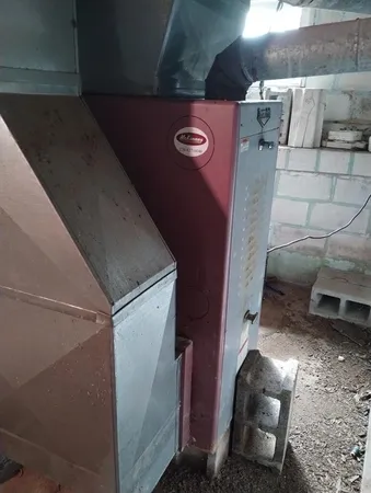 a brick house with plants in front of it