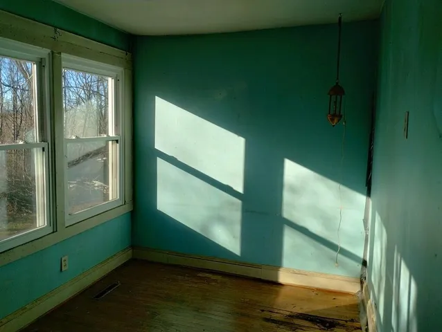 a view of room with window and hardwood floor
