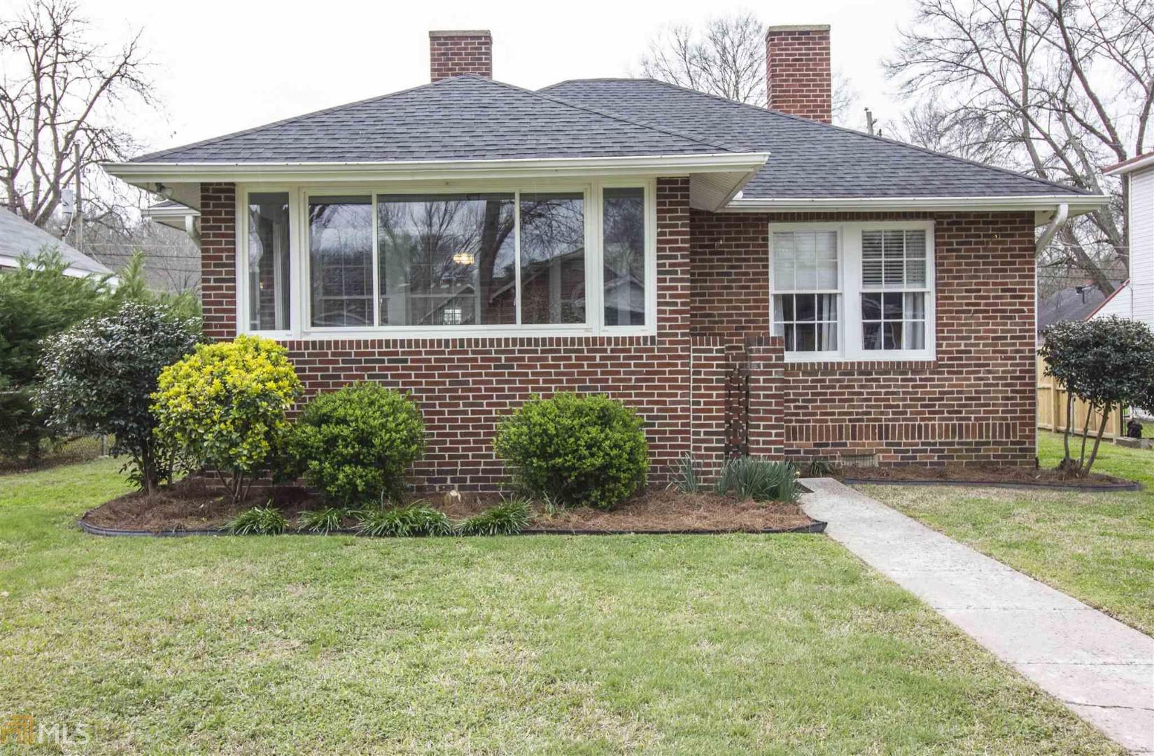 9 Elmwood Street Northeast Rome, GA 30161 - Photo 1 of 1 a front view of a house with garden
