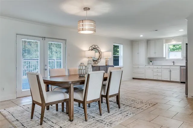 a view of a dining room with furniture and chandelier