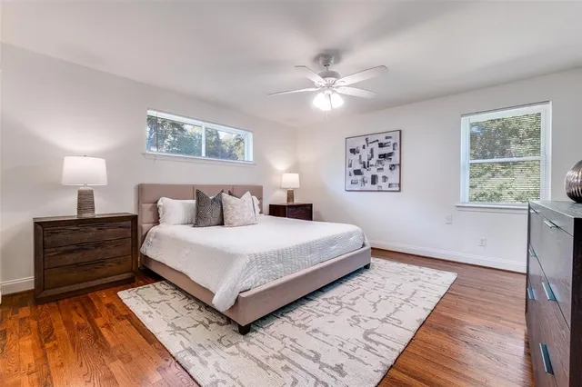 a bedroom with a large bed and a window