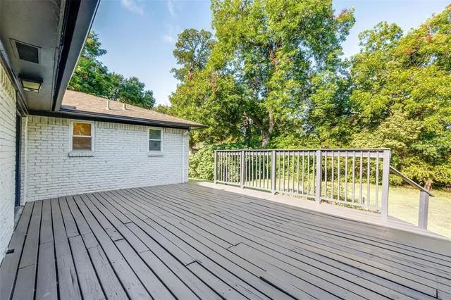 a view of backyard with a deck