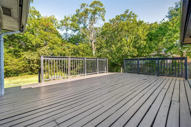 a view of a balcony with wooden floor