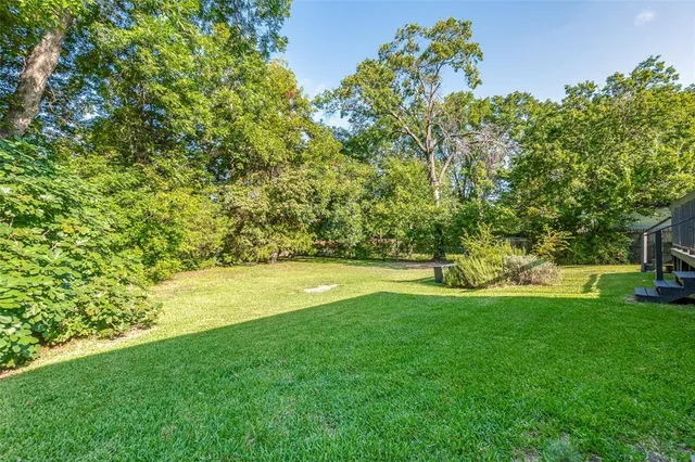 a view of yard with swimming pool and green space