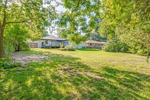 a view of a house with a yard and sitting area