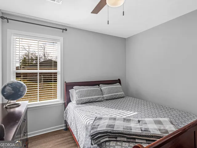 a bedroom with a bed and a window