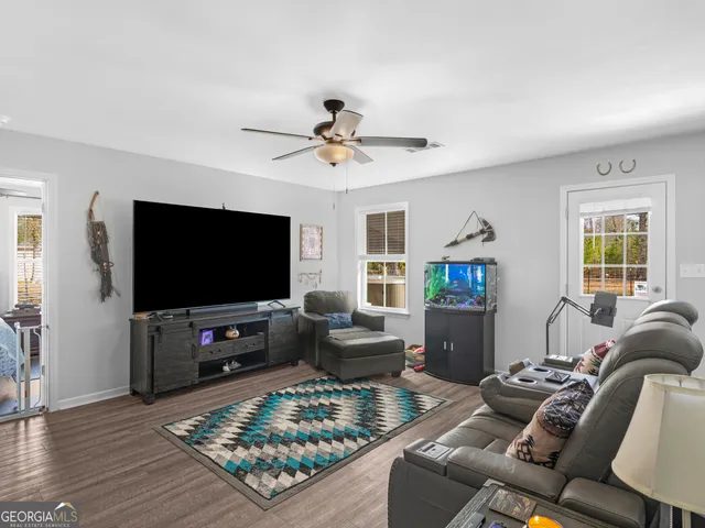 a living room with furniture and a flat screen tv