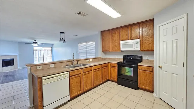 a kitchen with stainless steel appliances granite countertop a stove sink and cabinets